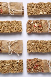 Photo of Different tasty granola bars on white background, flat lay