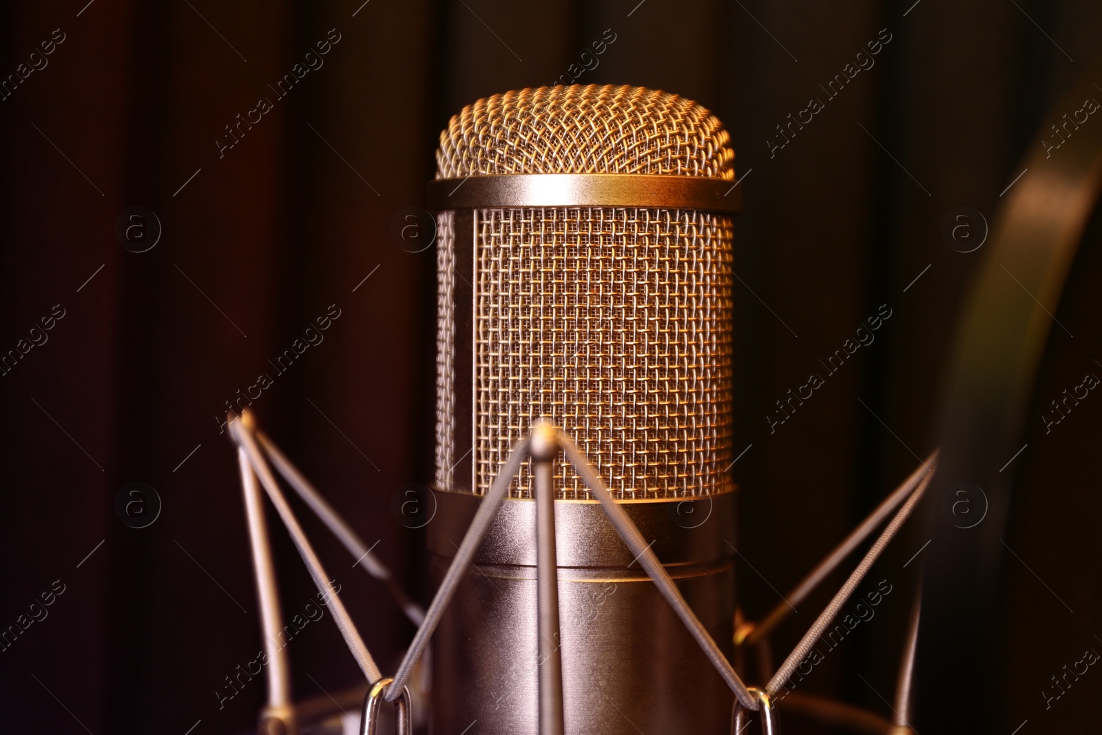 Photo of Condenser microphone in modern recording studio. Music equipment