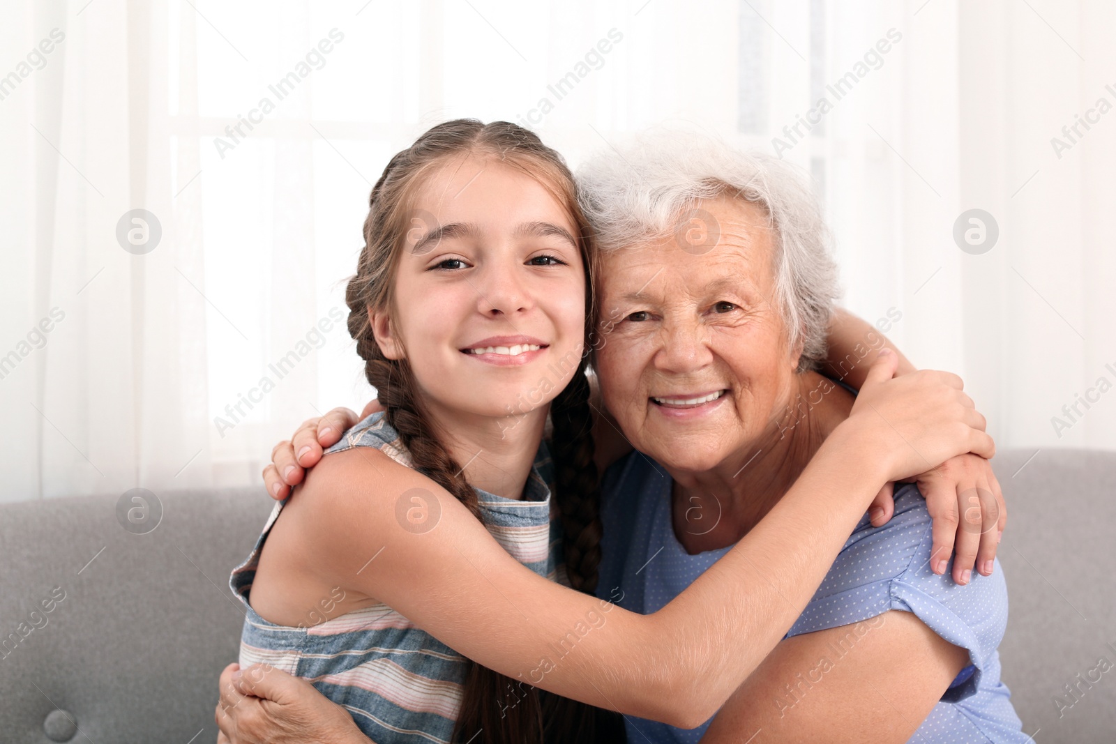 Photo of Happy cute girl with her grandmother at home