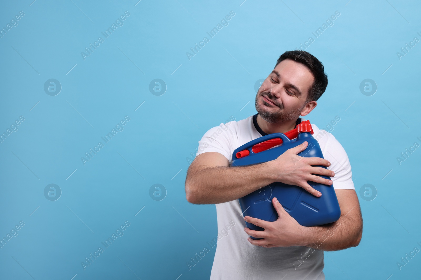 Photo of Man holding canister on light blue background, space for text