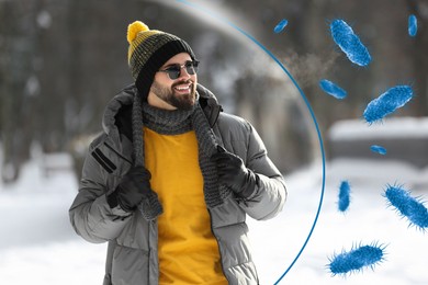 Man with strong immunity surrounded by viruses outdoors in winter