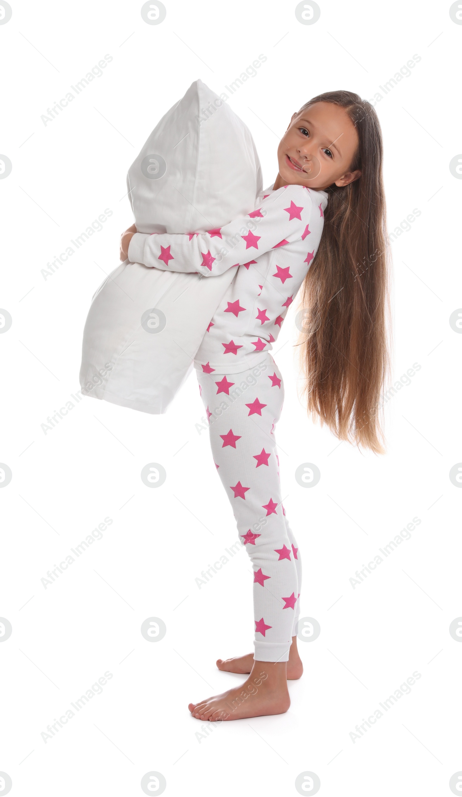 Photo of Cute girl wearing pajamas with pillow on white background