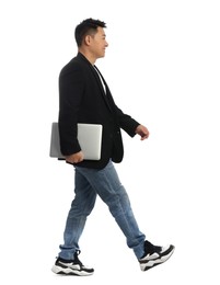 Man with laptop walking on white background