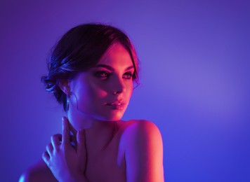 Portrait of beautiful woman posing in neon lights