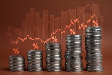 Image of Mortgage rate. Stacked coins, graphs and percent signs on brown background