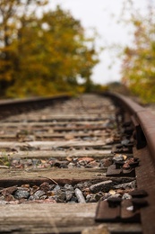 Railway line with track ballast in countryside, closeup. Train journey