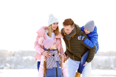 Photo of Portrait of happy family outdoors on winter day