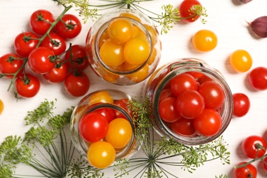 Pickling jars with fresh tomatoes on white background, top view