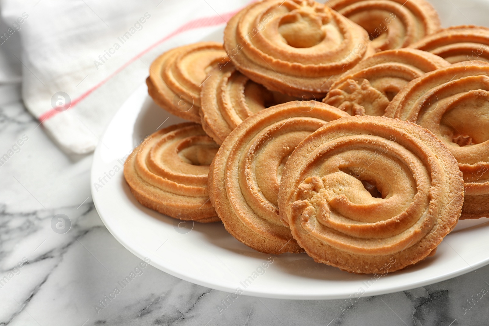 Photo of Plate with Danish butter cookies on marble table, closeup