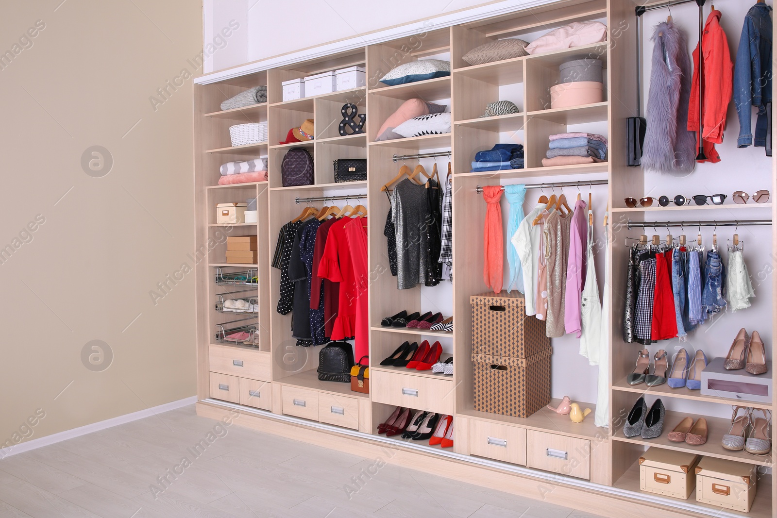 Photo of Large wardrobe with different clothes, home stuff and shoes