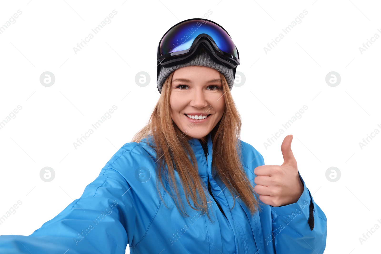 Photo of Beautiful woman in ski goggles taking selfie on white background