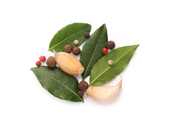 Photo of Aromatic bay leaves and spices isolated on white, top view