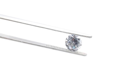 Photo of Tweezers with beautiful shiny diamond isolated on white