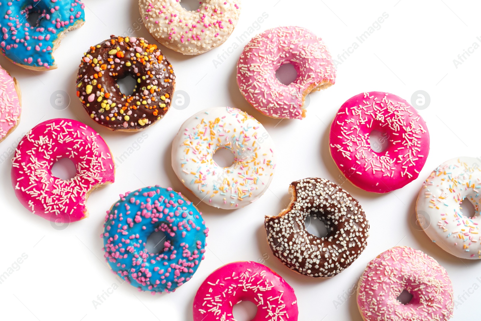 Photo of Delicious doughnuts with sprinkles on light background, top view