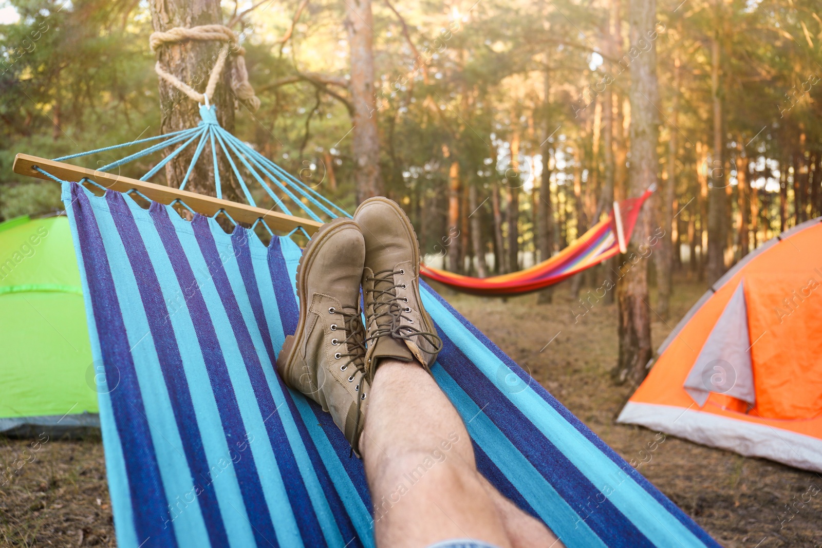 Photo of Man resting in comfortable hammock outdoors, closeup