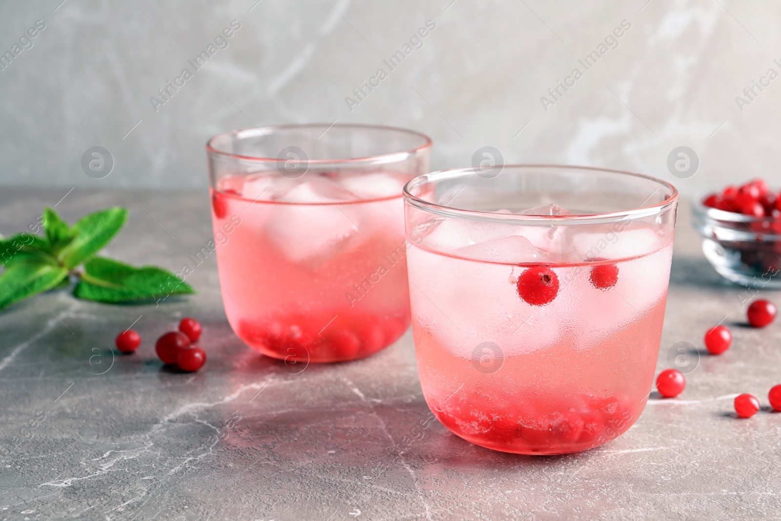 Photo of Refreshing natural lemonade in glasses on table