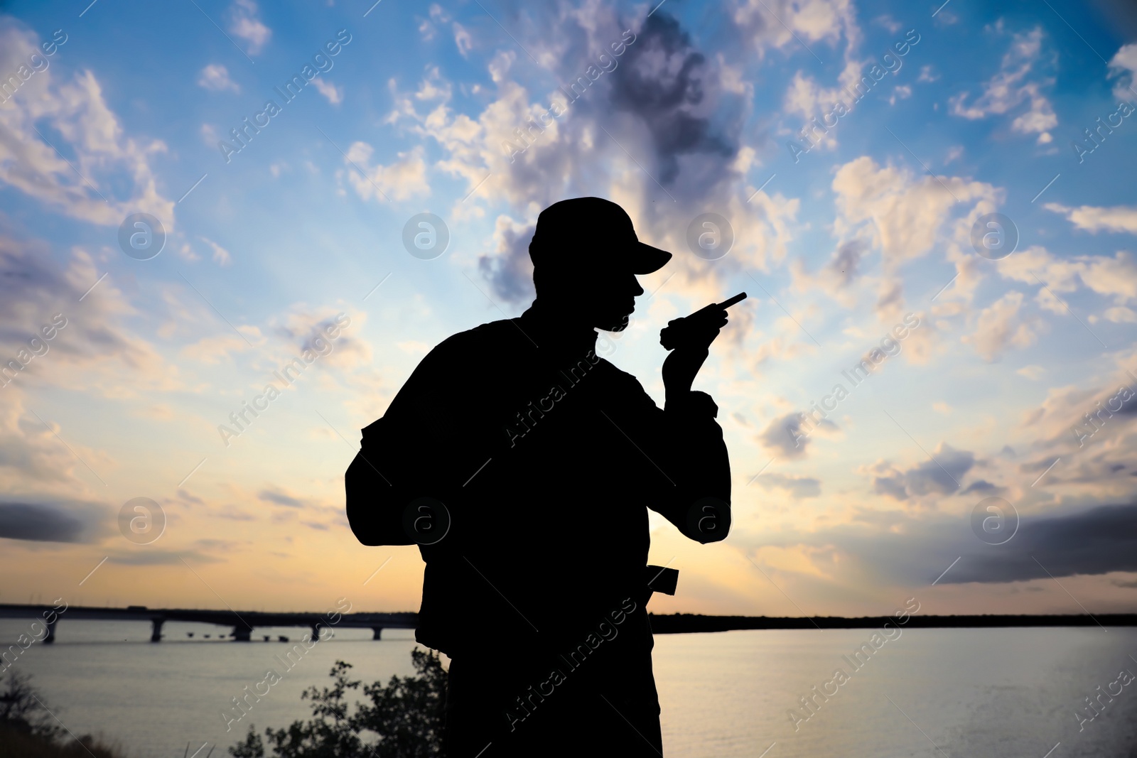 Photo of Soldier with portable radio transmitter outdoors. Military service