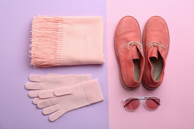 Photo of Flat lay composition with warm clothes on color background