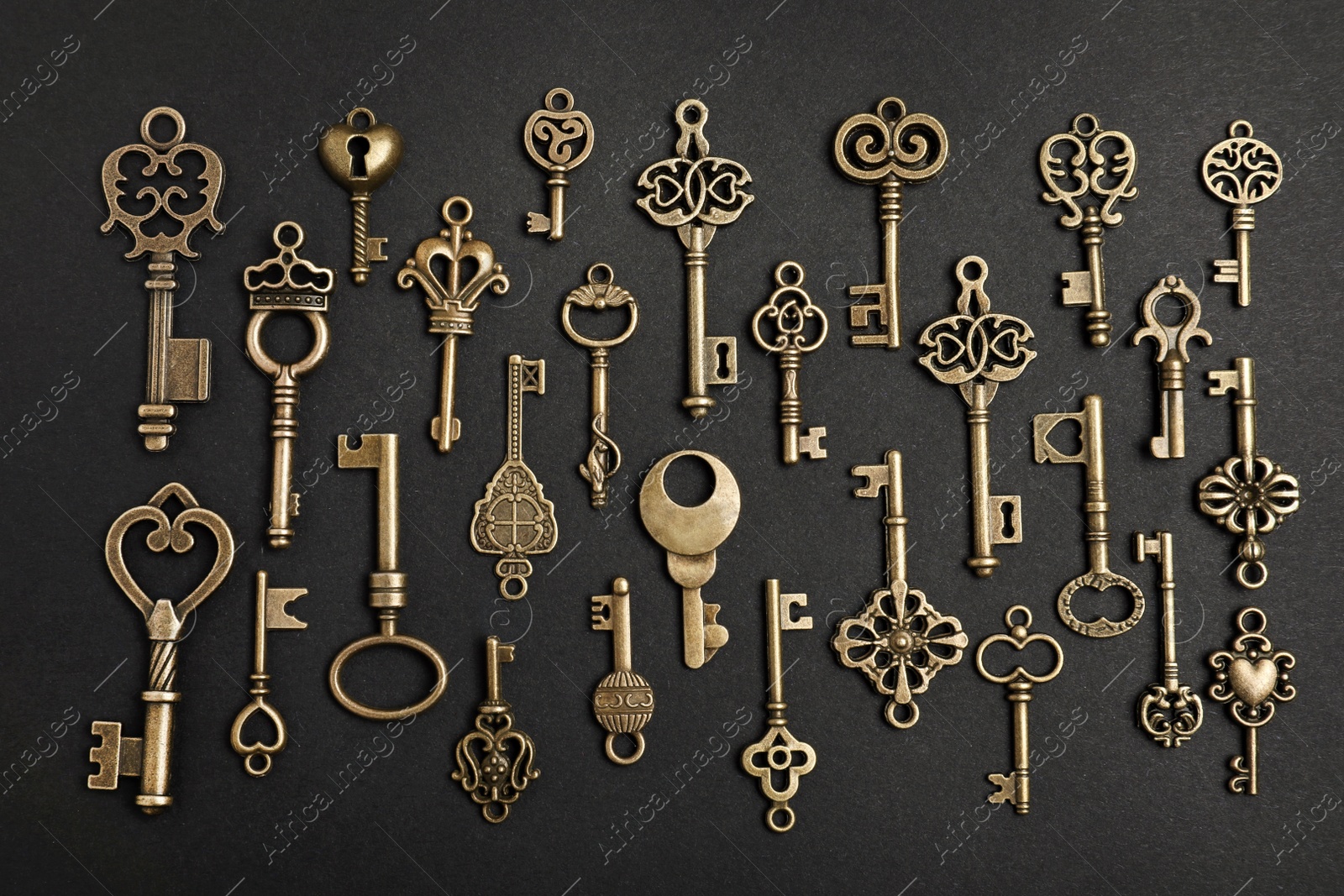 Photo of Flat lay composition with bronze vintage ornate keys on dark background