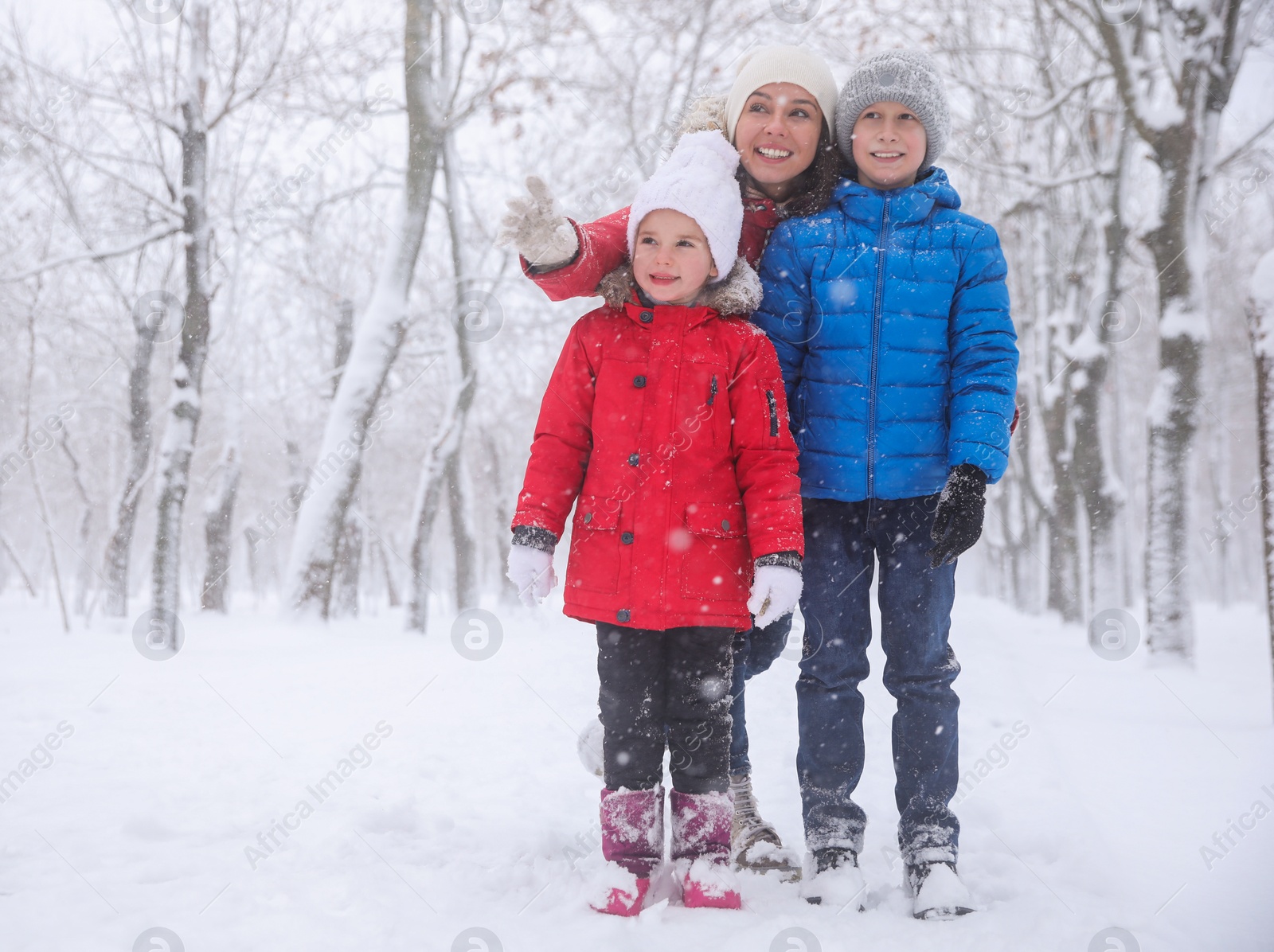 Photo of Woman with her children spending time outside on winter day. Christmas vacation