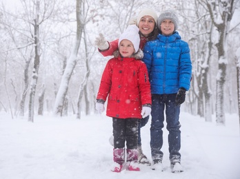 Woman with her children spending time outside on winter day. Christmas vacation