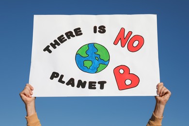 Photo of Man with poster protesting against climate change outdoors, closeup