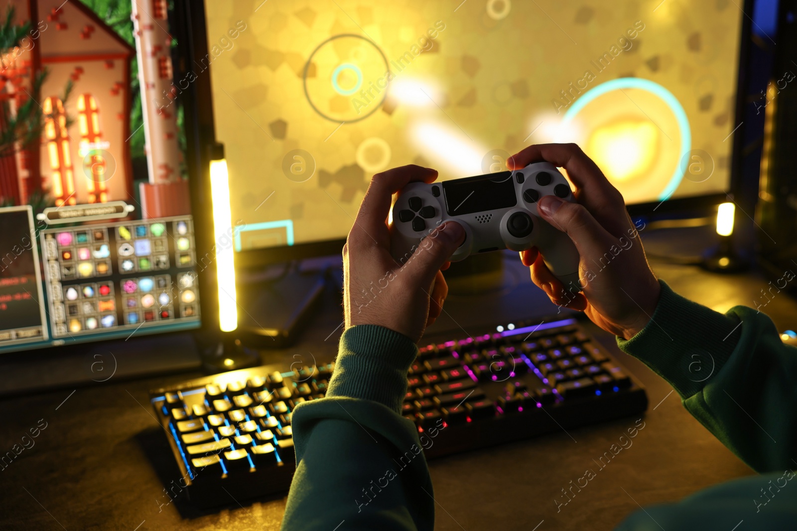 Photo of Man playing video games with controller at table indoors, closeup