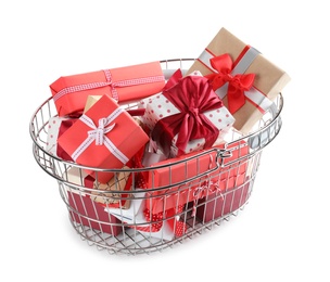 Photo of Shopping basket full of gift boxes on white background