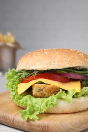 Photo of Delicious burger with tofu and fresh vegetables on table, closeup