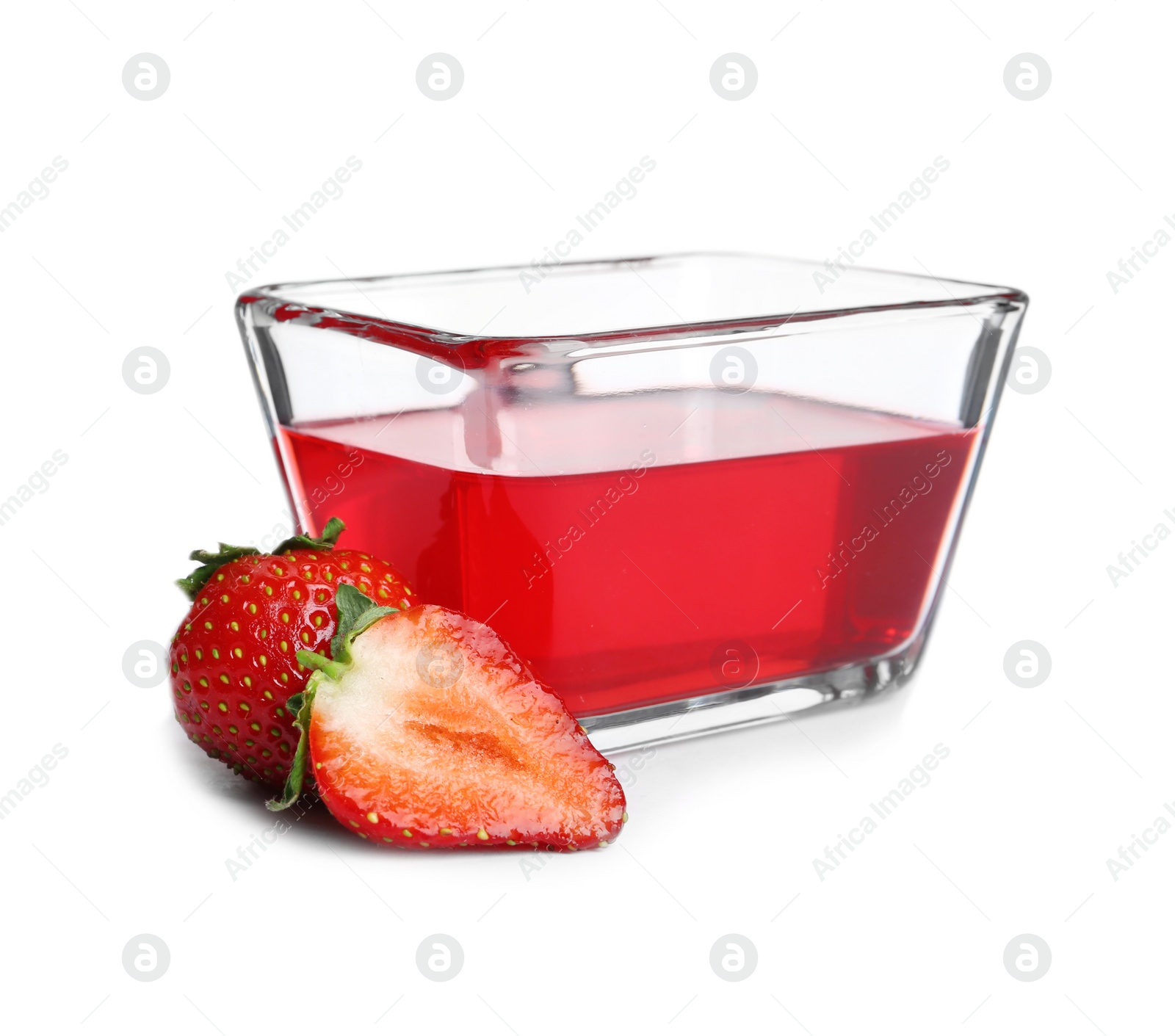 Photo of Strawberries and tasty jelly dessert in glass bowl on white background