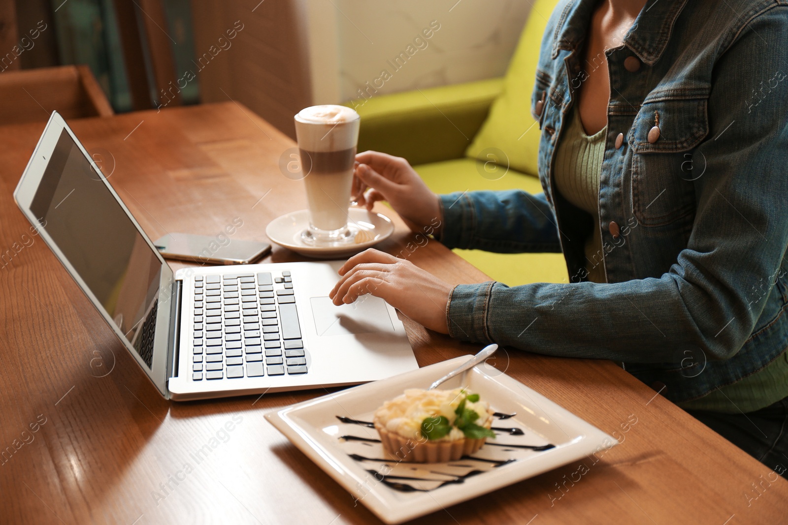 Photo of Blogger working with laptop in cafe, closeup