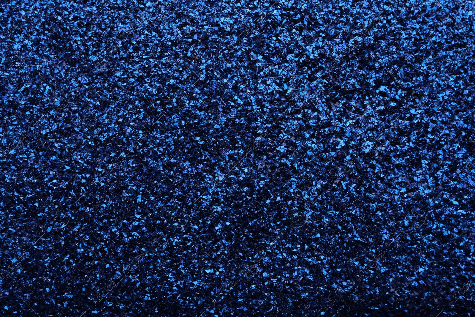 Photo of Beautiful shiny blue glitter as background, closeup