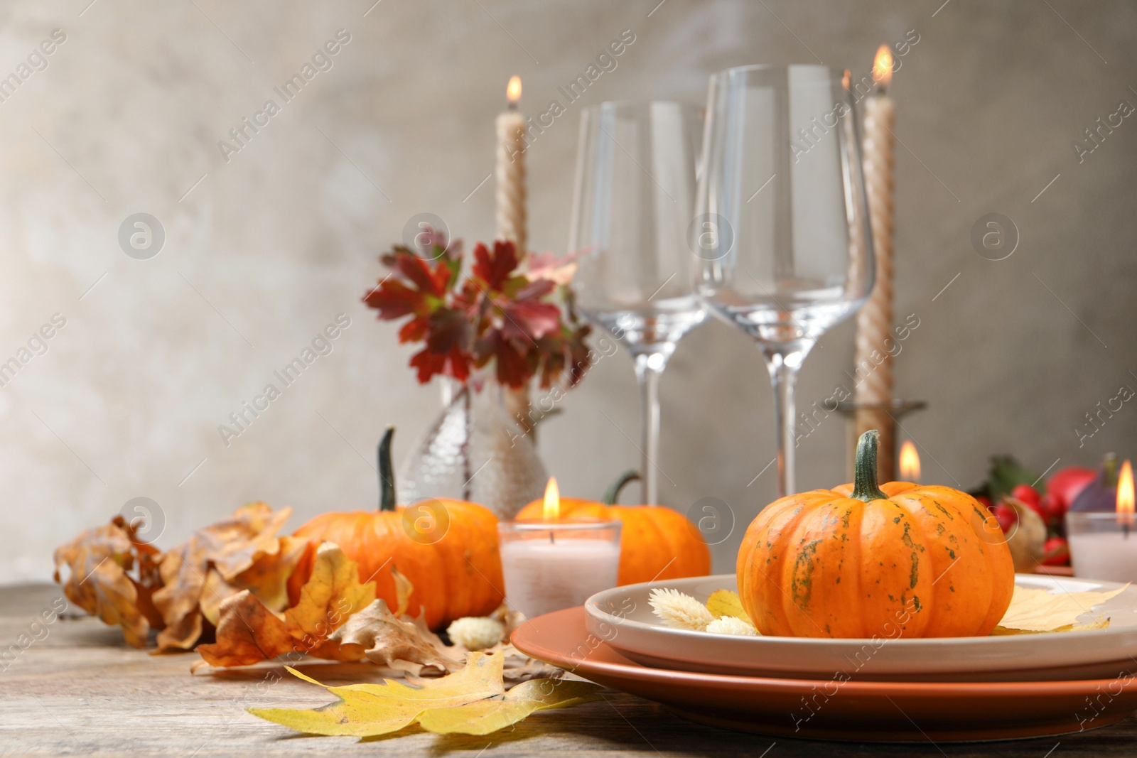 Photo of Beautiful autumn place setting and decor on wooden table, space for text