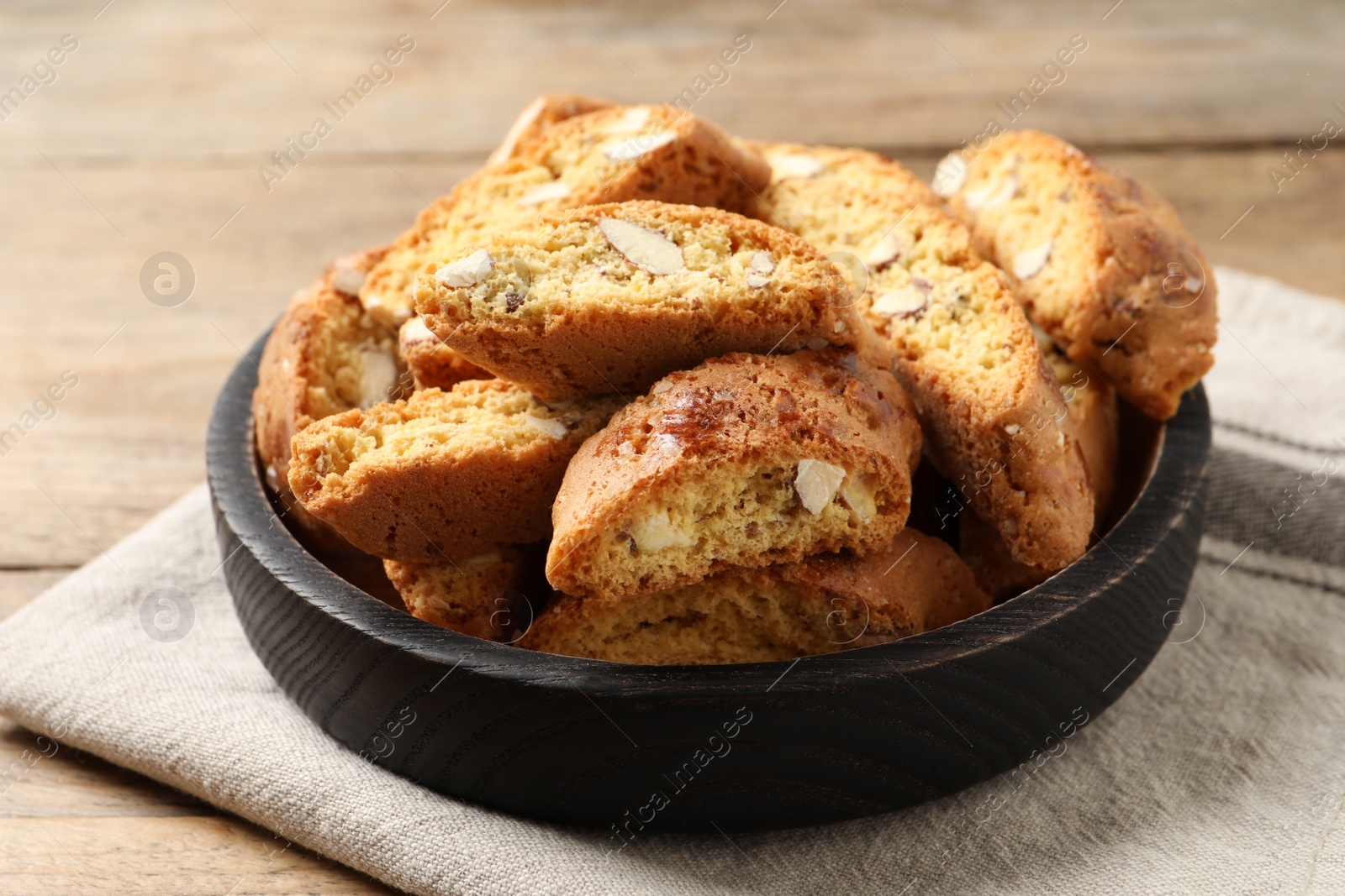 Photo of Traditional Italian almond biscuits (Cantucci) on wooden table