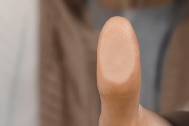 Woman pressing finger to surface, closeup view. Scanning fingerprint