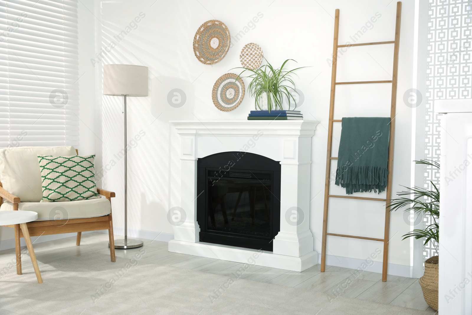 Photo of Wooden ladder near fireplace in stylish room