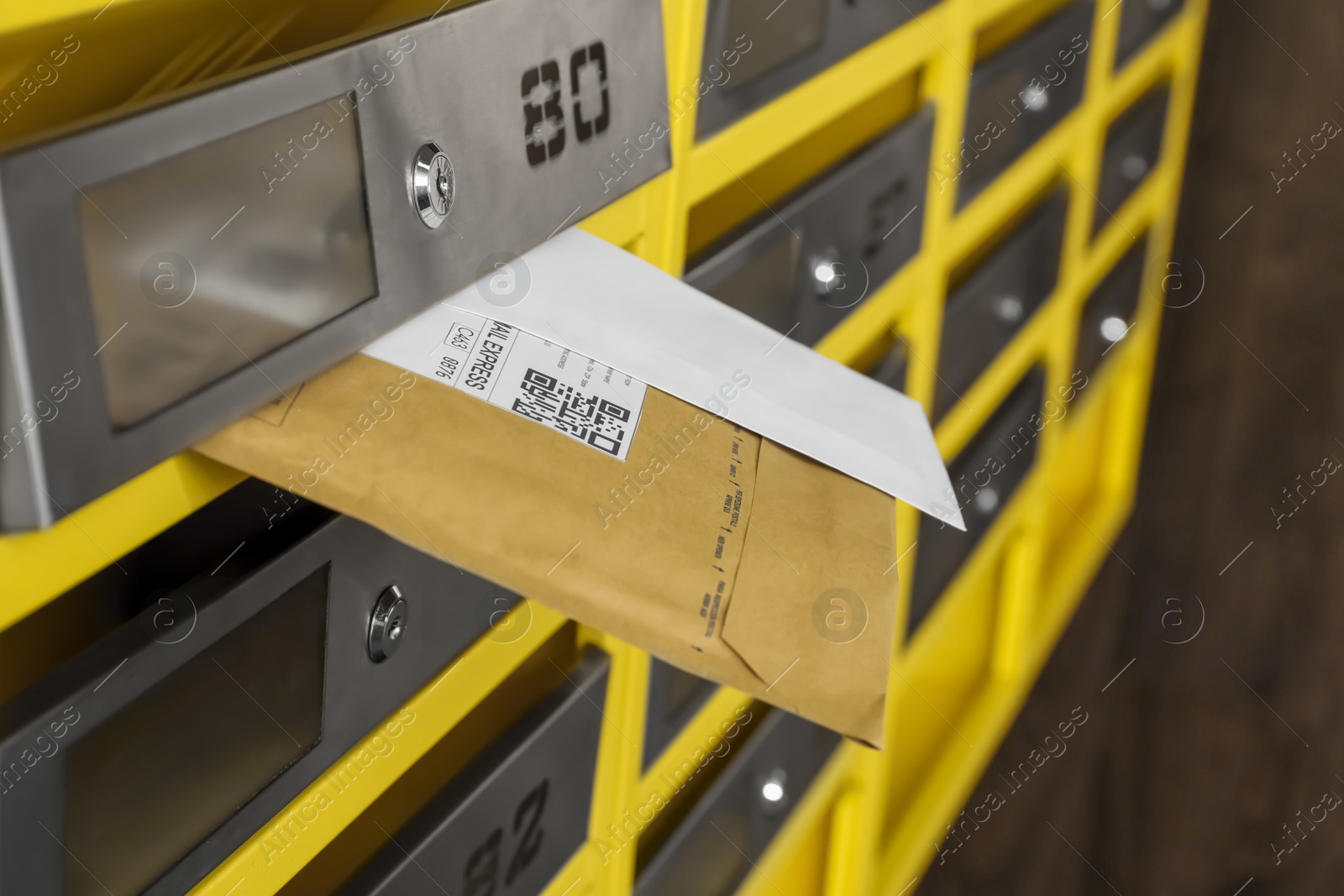 Photo of Metal mailboxes with keyholes, numbers and correspondence in post office, closeup