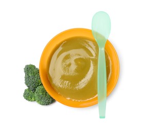 Delicious baby food, spoon and fresh broccoli in bowl isolated on white, top view