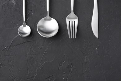 Photo of Beautiful cutlery set on black table, flat lay. Space for text