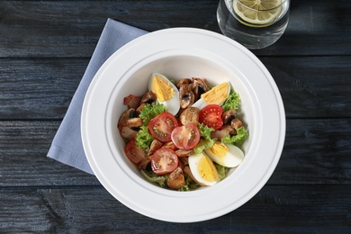 Photo of Plate with delicious fresh salad on table