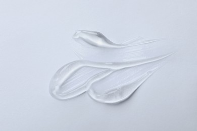 Photo of Swatches of cosmetic gel on white background, top view