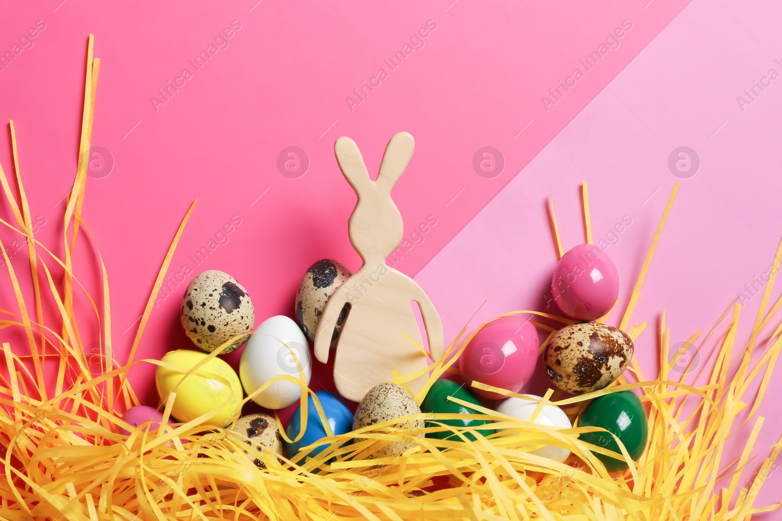 Photo of Flat lay composition of Easter bunny figure and eggs on color background