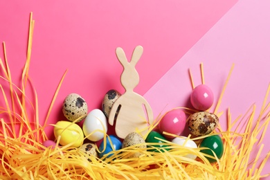 Flat lay composition of Easter bunny figure and eggs on color background