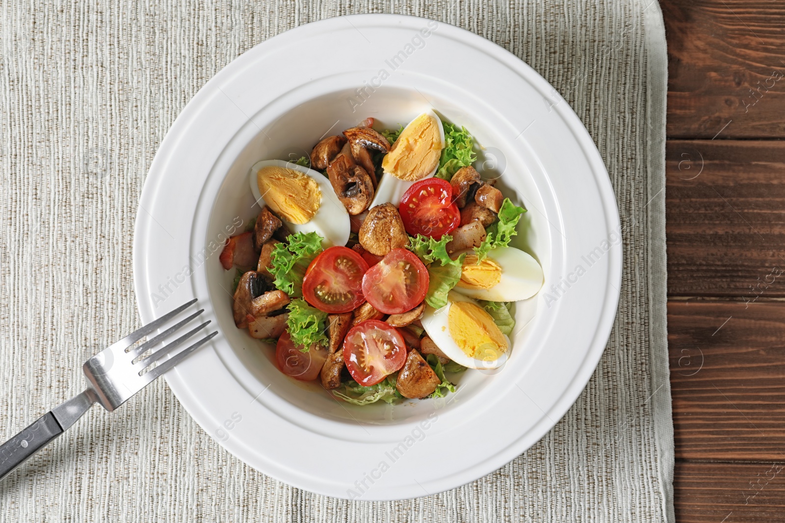 Photo of Plate with delicious fresh salad on table, top view