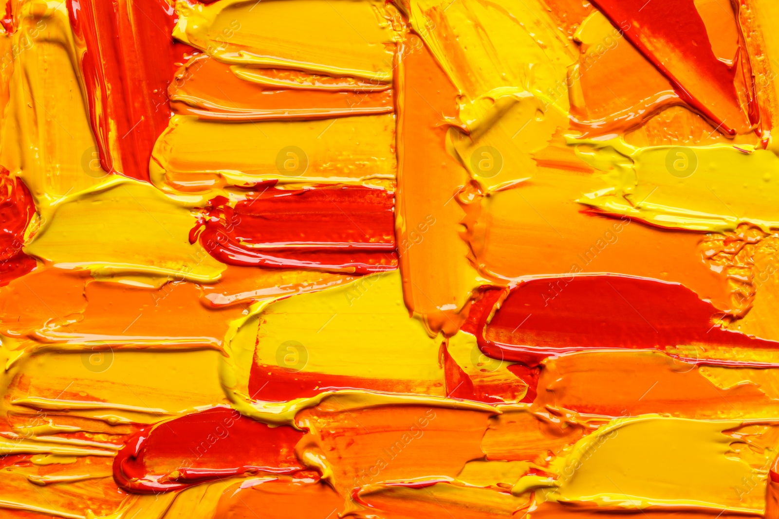 Photo of Beautiful strokes of colorful oil paints as background, closeup