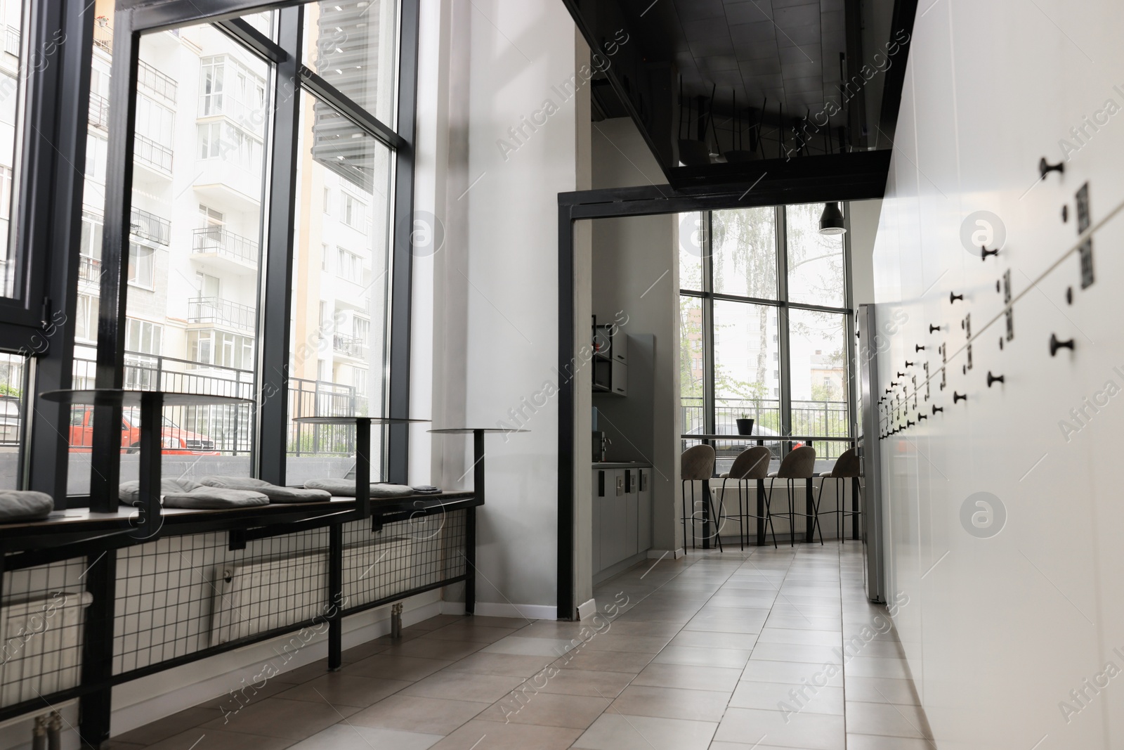 Photo of Hostel dining room interior with modern furniture and white lockers