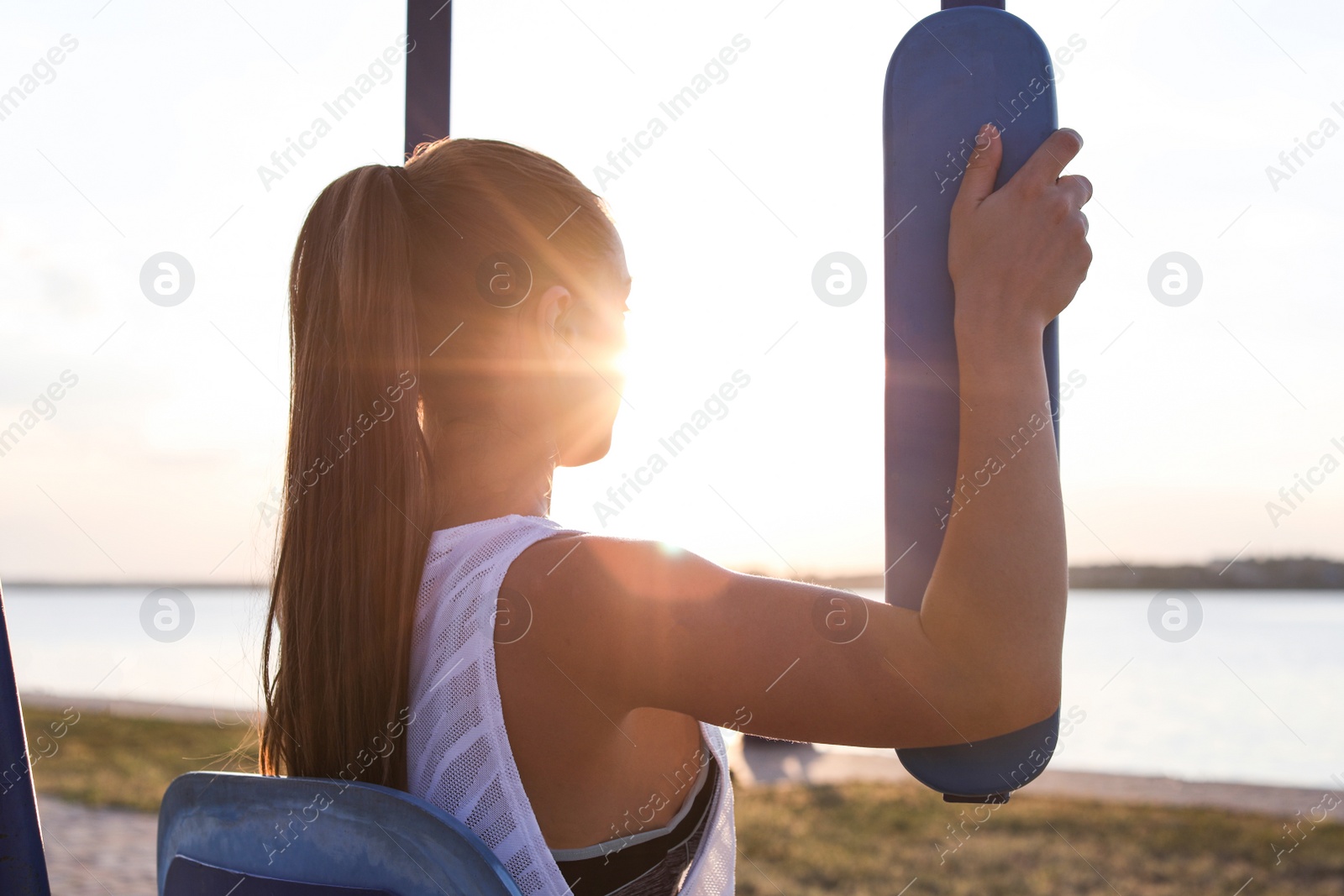 Photo of Young woman training near river in morning