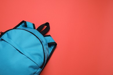 Stylish light blue backpack on red background, top view. Space for text