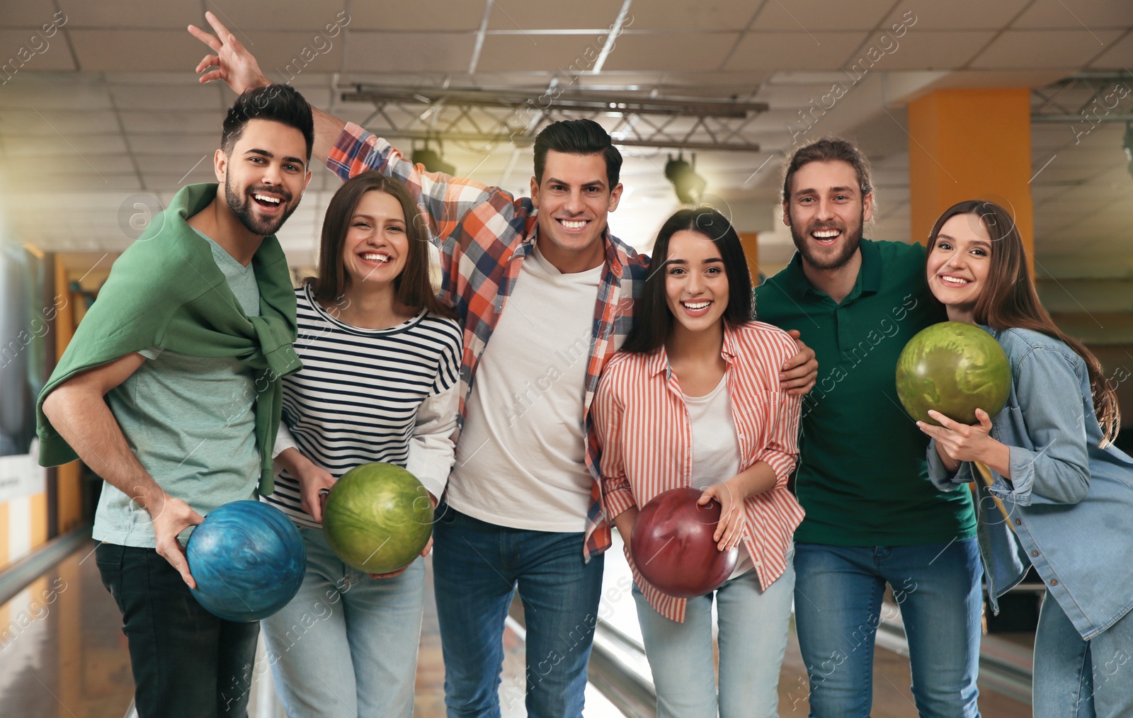 Photo of Group of friends with balls in bowling club