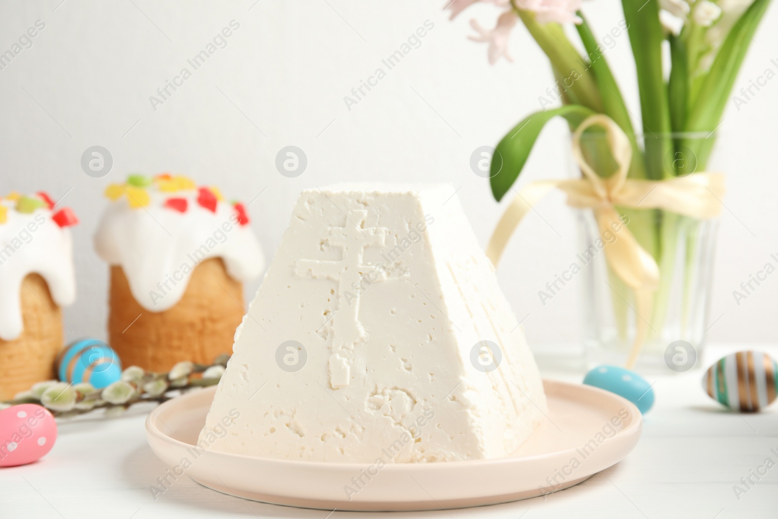 Photo of Traditional cottage cheese Easter paskha on white wooden table